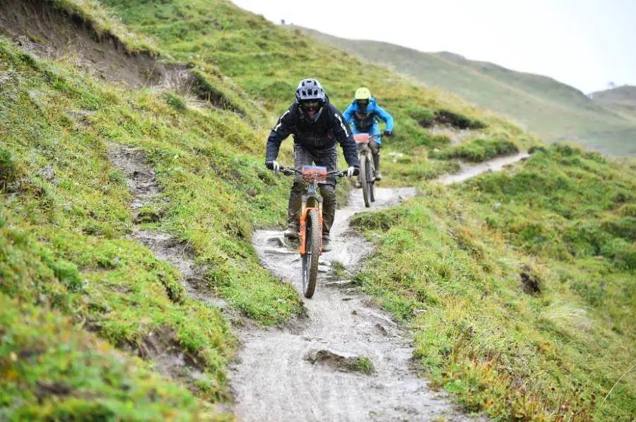 Mountainbike Rider Claudio Negro ist auf nassen Trails unterwegs und von unten bis Oben mit Dreck eingeschmiert